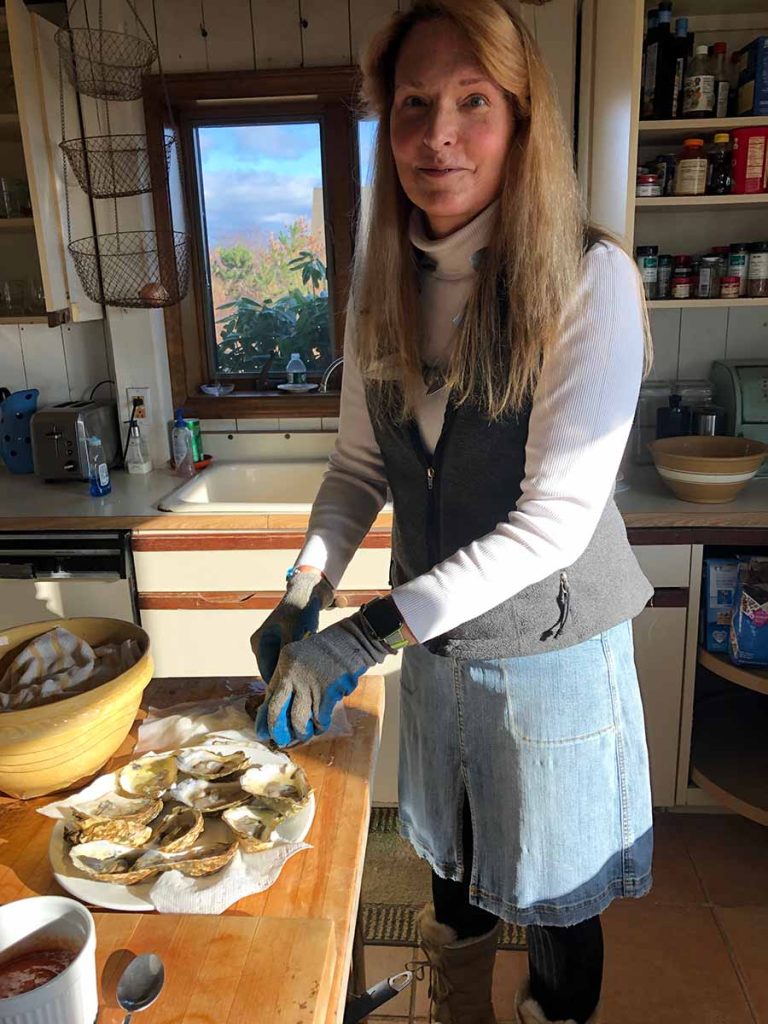 Carole preparing oysters in kitchen